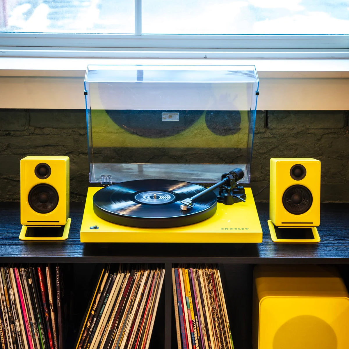 Yellow Crosley turntable with matching Audioengine speakers