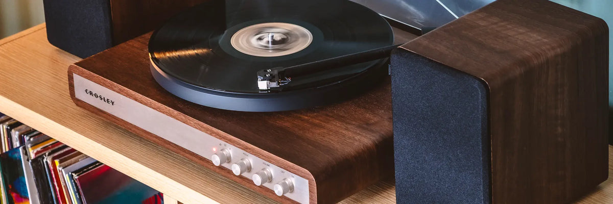 Crosley C65 turntable and stereo speakers playing a vinyl record